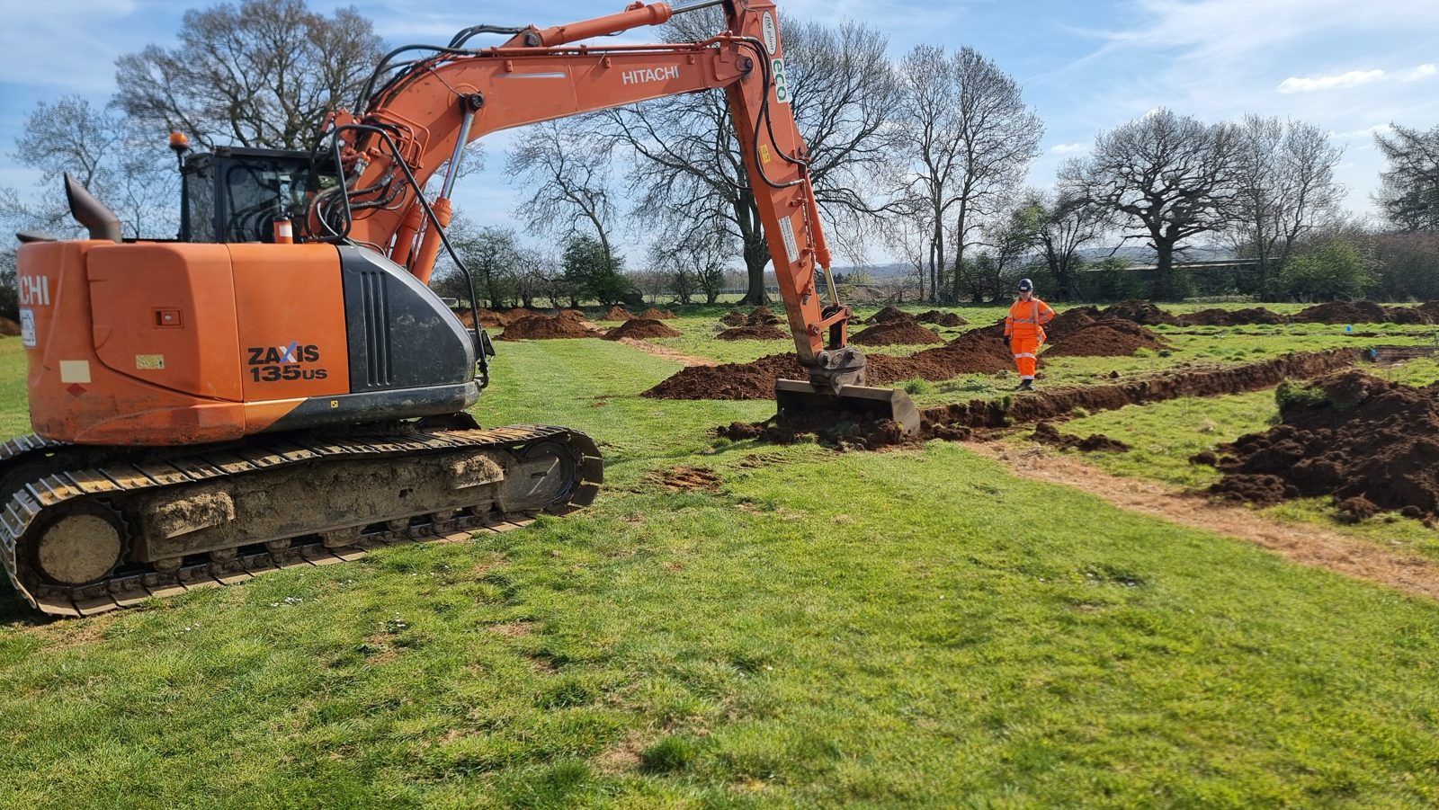 A tracked excavator carrying out archaeological trenching at a 26MW solar site in Northamptonshire.