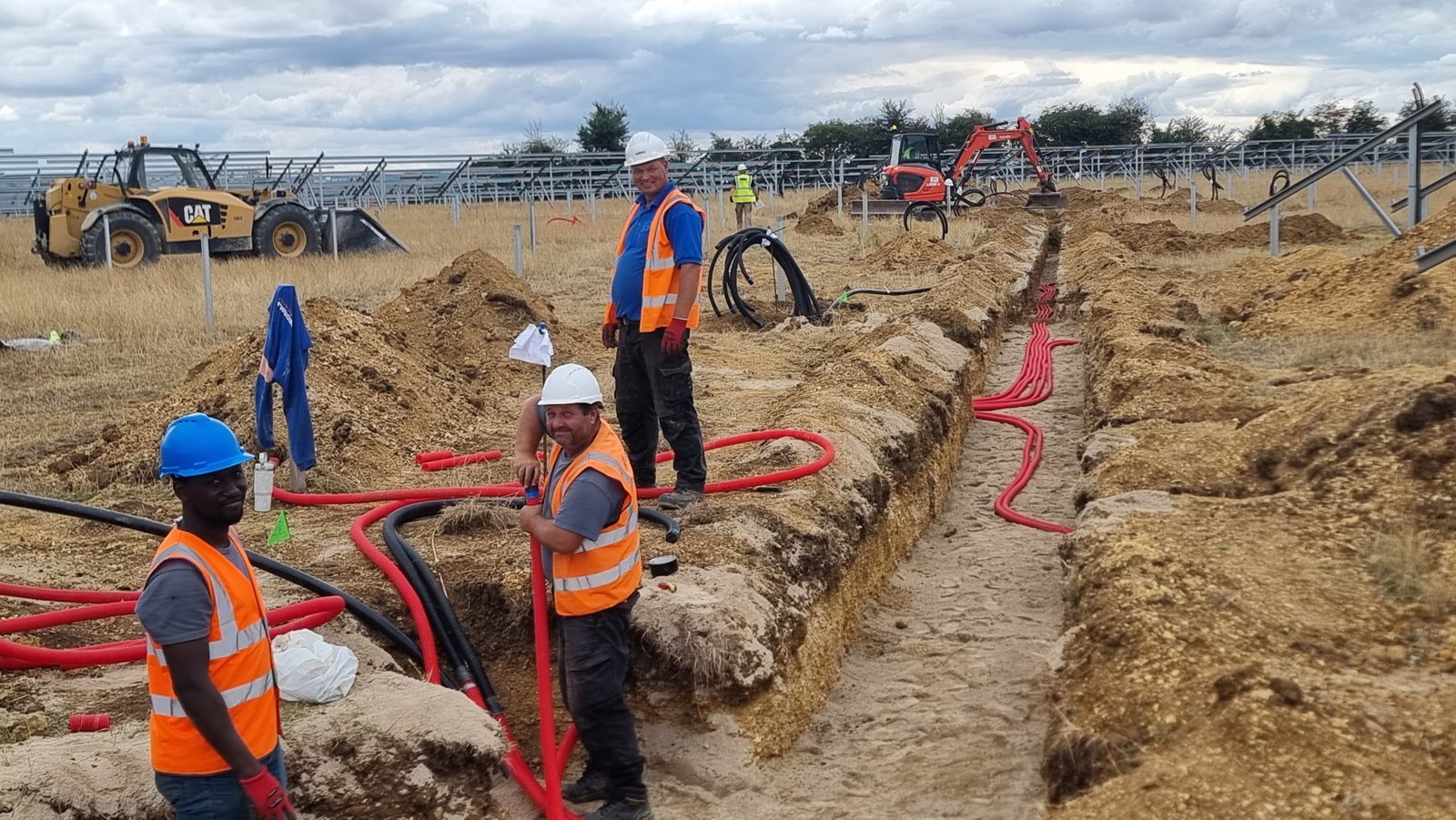 Cable ducting being installed in a trench at a 29MW solar site in Oxfordshire.