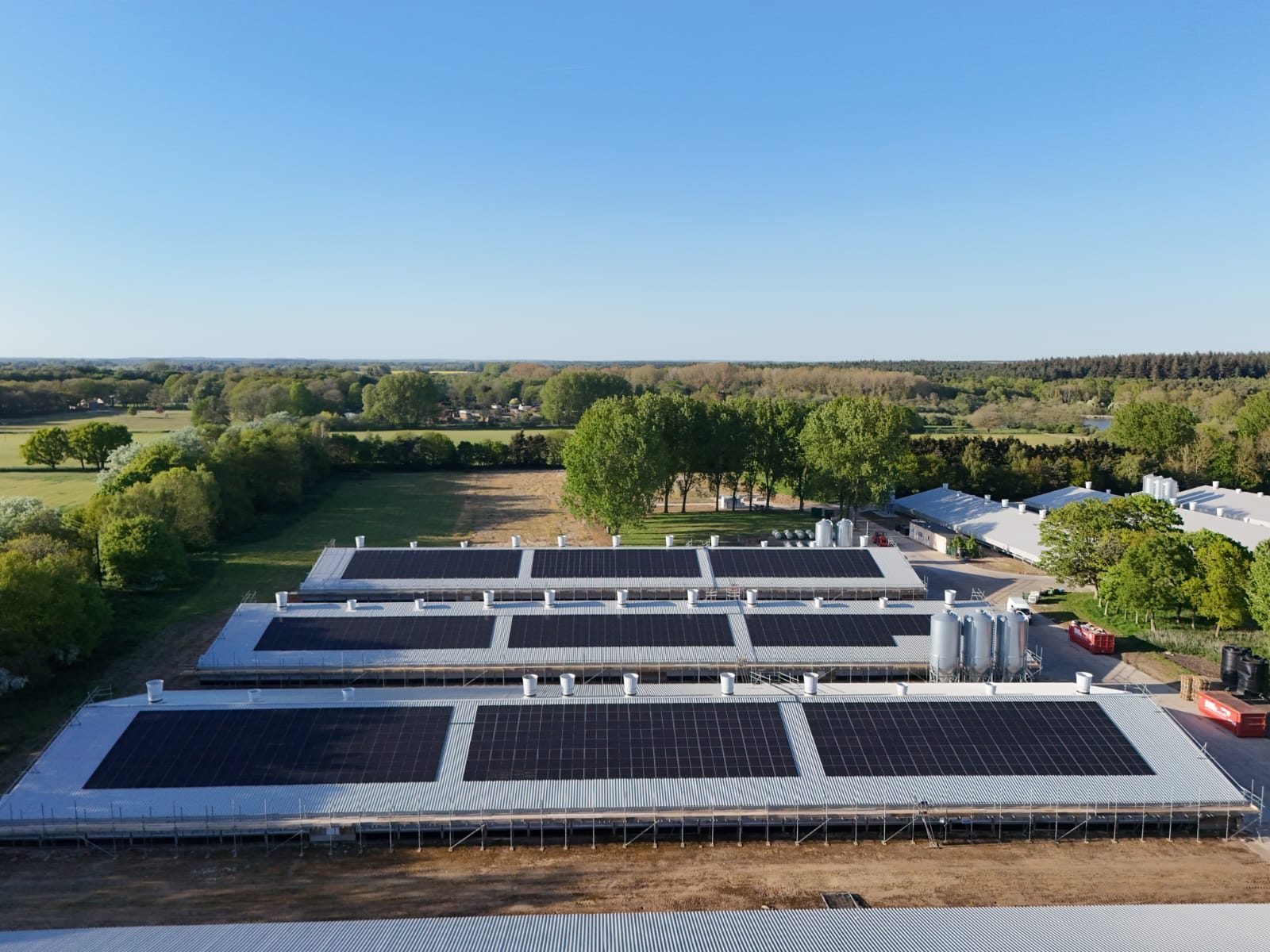Aerial view of rooftop solar panels installed across poultry farm buildings at Amber Farm, Norfolk.