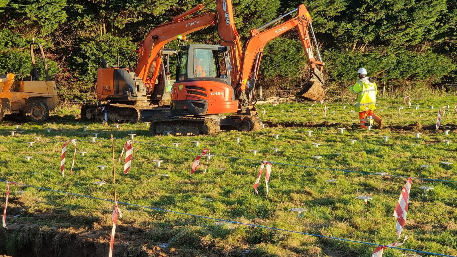 Excavators stripping foundations at a solar and BESS site.